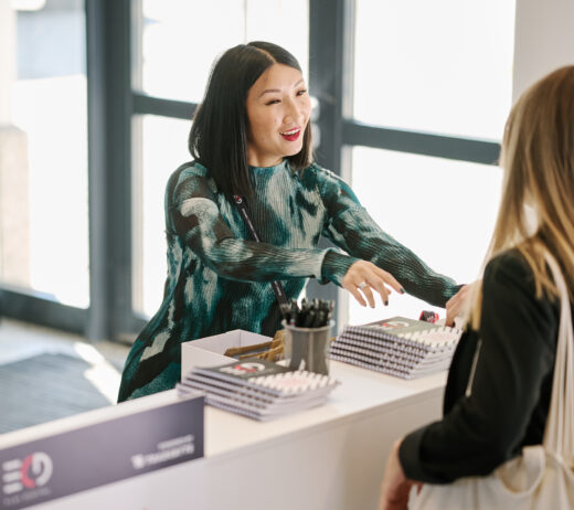 Woman at fair smiling and talking to guest